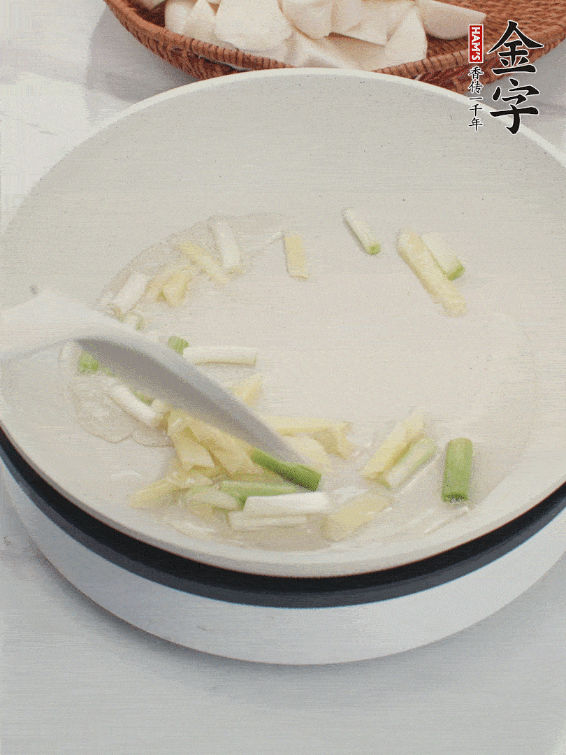 鍋中油五成熱，下蔥白、姜片爆香。