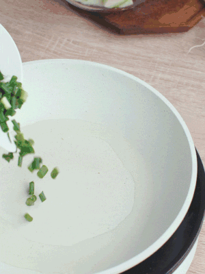 熱油下臘肉、蔥花煸炒，再下西葫蘆。